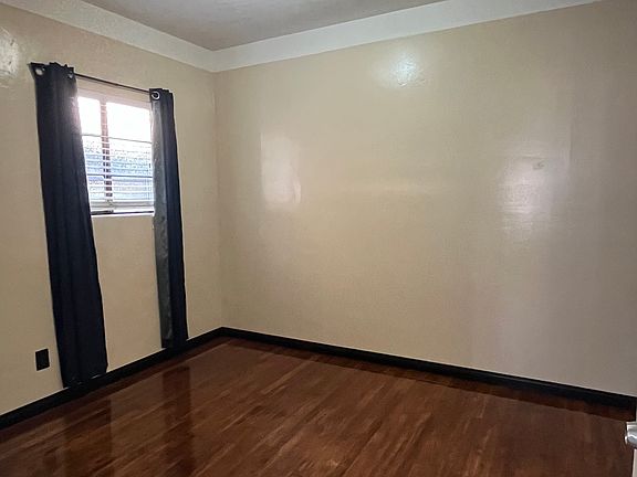 Bedroom with freshly coated oak floor, and newly painted walls.