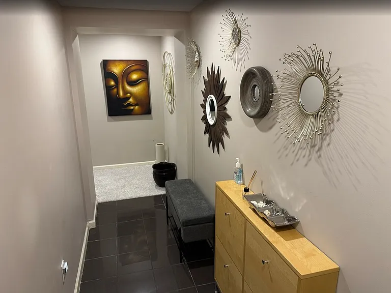 Welcoming entry foyer with built-in bench seating, tasteful decor, and shoe storage.