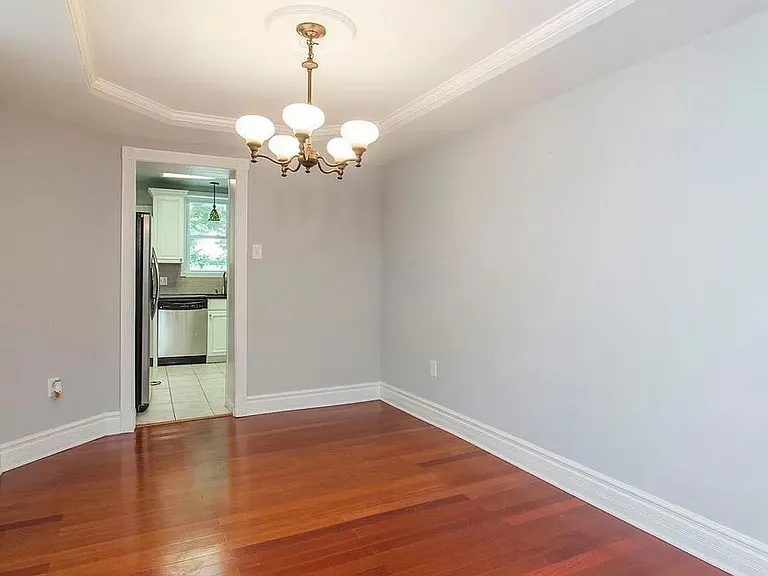 Unfurnished Dining Room with previous Chandelier. View from outside Powder Room Door.
