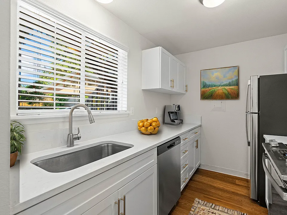 Experience culinary bliss in this modern, sunlit kitchen designed for functionality and style.