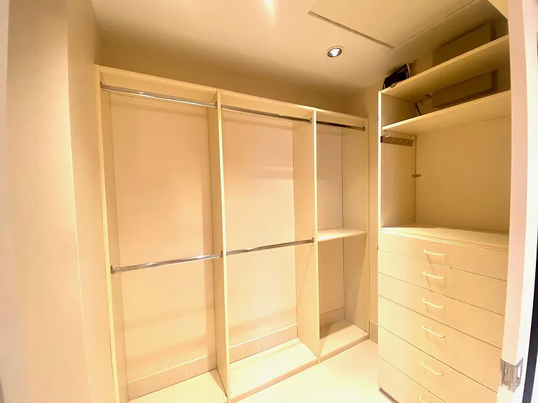 Master bedroom closet with built in drawers