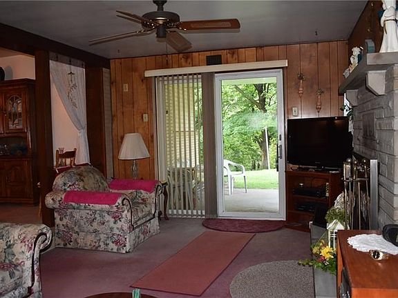 The Living Room Also Features Fireplace & Access To The Back Patio