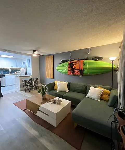living room with couch, coffee table, kayak