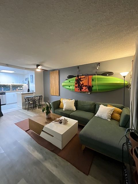 living room with couch, coffee table, kayak
