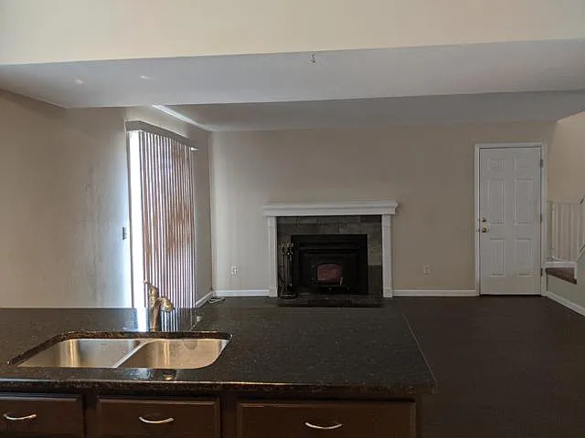 Family room but great for use as a dining room. Slider to the deck. Door to the garage. Easy care tile floor. Fireplace surround updated 3 years ago.