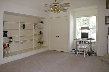 The spacious game room has a built-in bookcase and a closet.