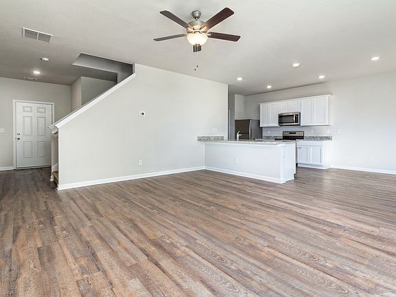 Open living room, adjacent to the kitchen, cultivates an area perfect for game nights.