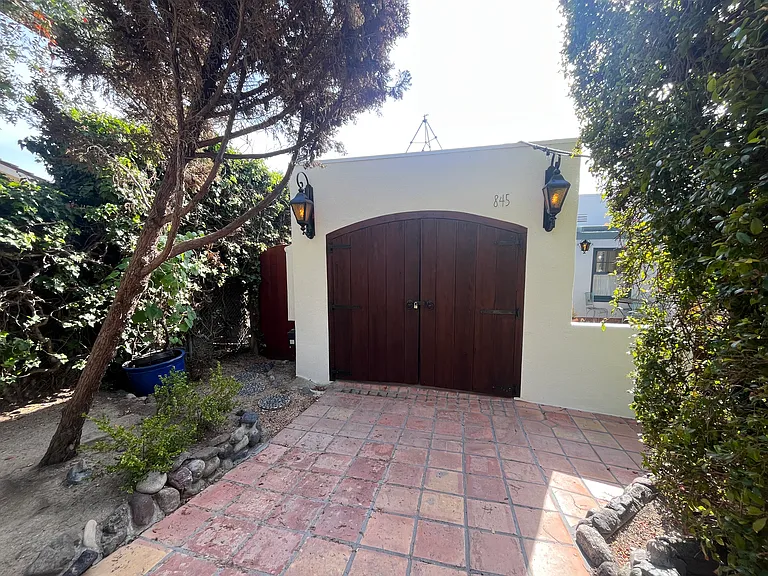 Saltillo tile entry way, with lower level access to the left, redwood gated, private entry