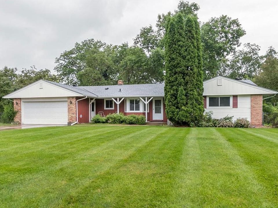 Front of house and large open front yard. 2 car attaches garage