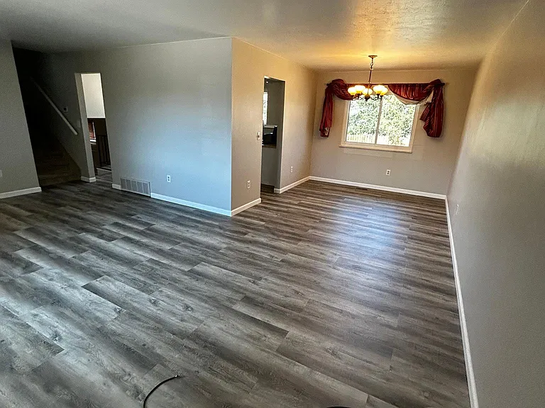 living room/ dining room with 2 kitchen entrances.