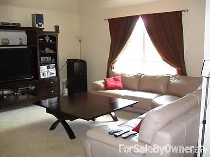 Living Room : Has 9+ vaulted ceiling with ceiling fan.