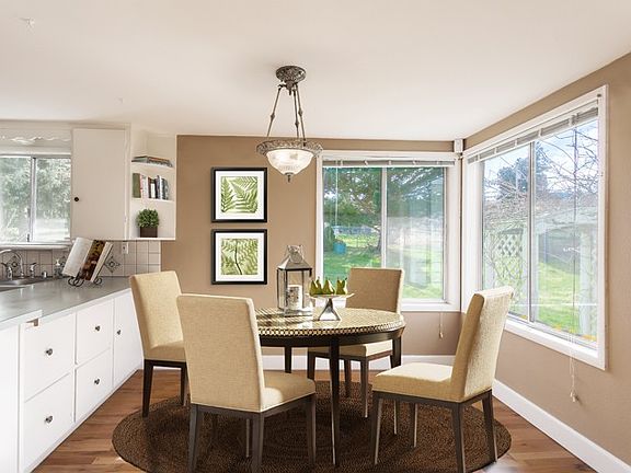Dining area is conveniently located next to kitchen, with vintage hardwood floors; open to living room this is sure to be the hub of entertainment fun! 