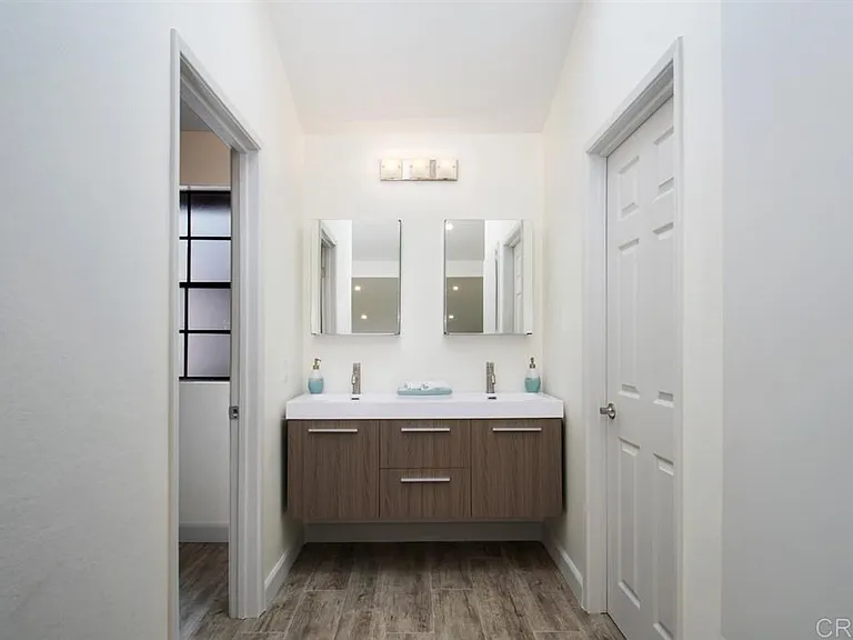Spacious and Modern En-Suite Bathroom

This generously sized en-suite bathroom, located within the condominium, offers a modern and functional design. The dual sinks with their sleek faucets provide ample space for two people to get ready simultaneously.