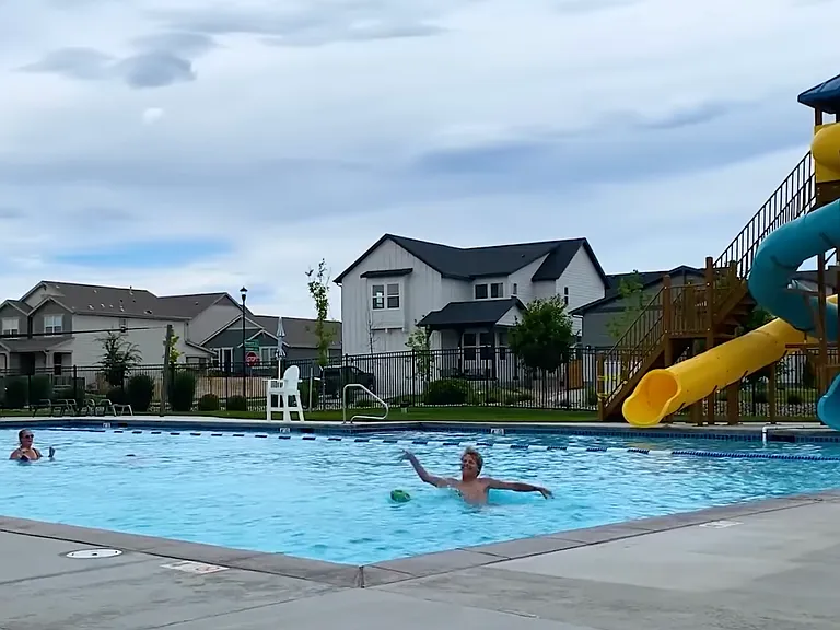 2 of 2 community pool. This one has 2 water slides, olympic size, life guards on duty, a separate baby pool, and tables and chairs for relaxing