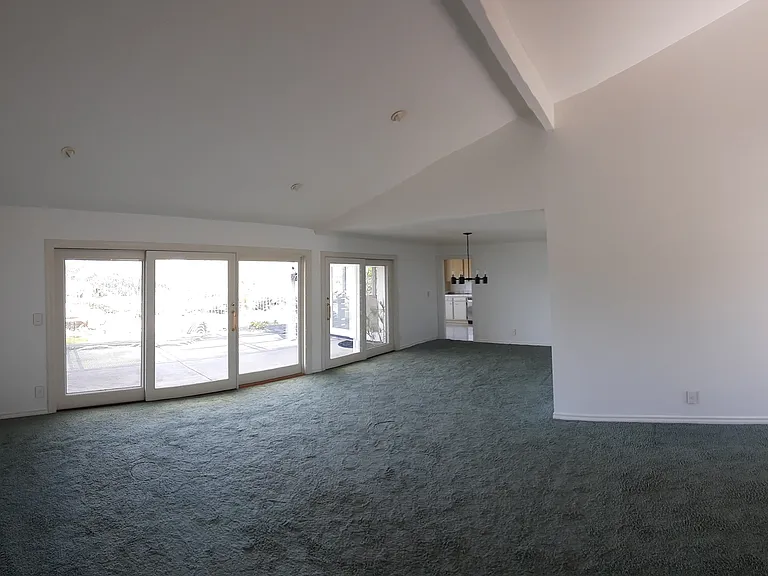 Living room open to dining and entry hall