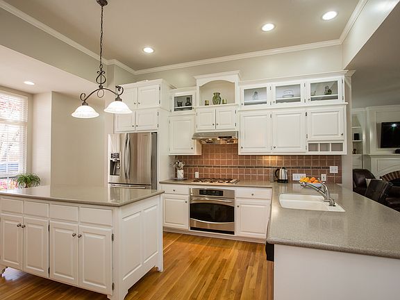 Additional Kitchen highlights include, updated neutral paint palette, tall ceiling with crown moulding, recessed lighting and custom cabinetry with wine/china storage. 