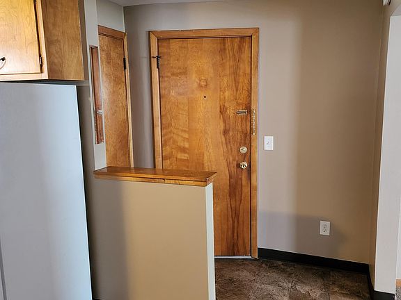 Entryway from the main hallway and storage closet door to the left are shown.