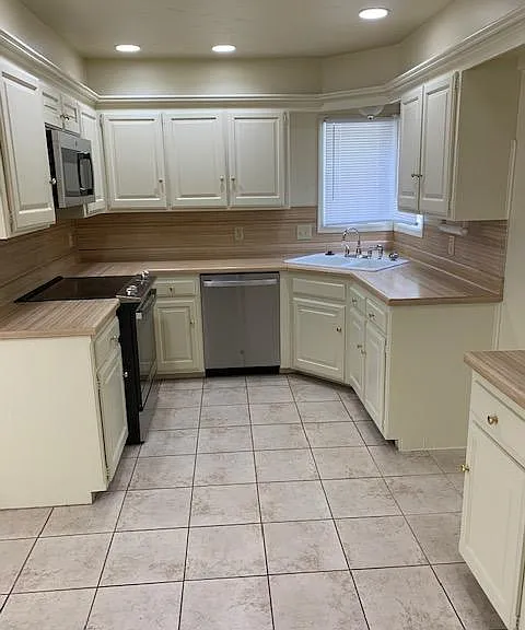 Kitchen With Stainless Steel Stove, Dishwasher and Microwave (Tenant Provides Refrigerator).