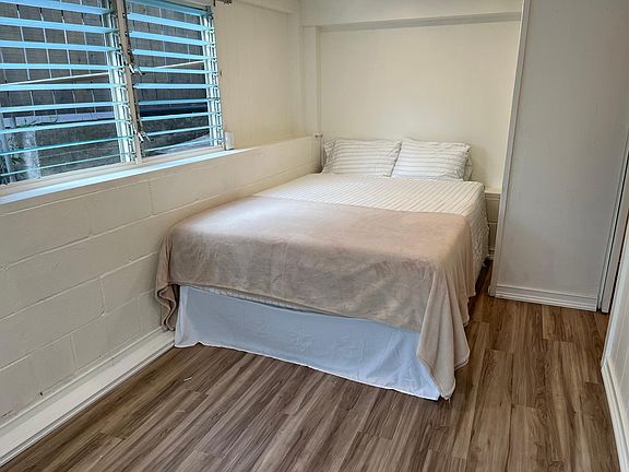 New Queen Mattress with remote-controlled adjustable bed frame. Sit up in bed to watch your 43-in mounted Roku TV.