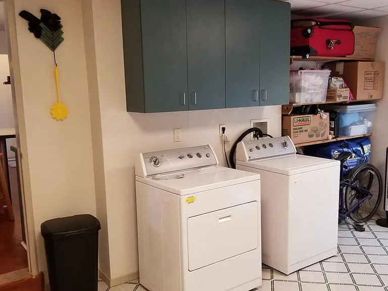 Laundry room with washer dryer, storage. To right is area large enough for kids pay area or office