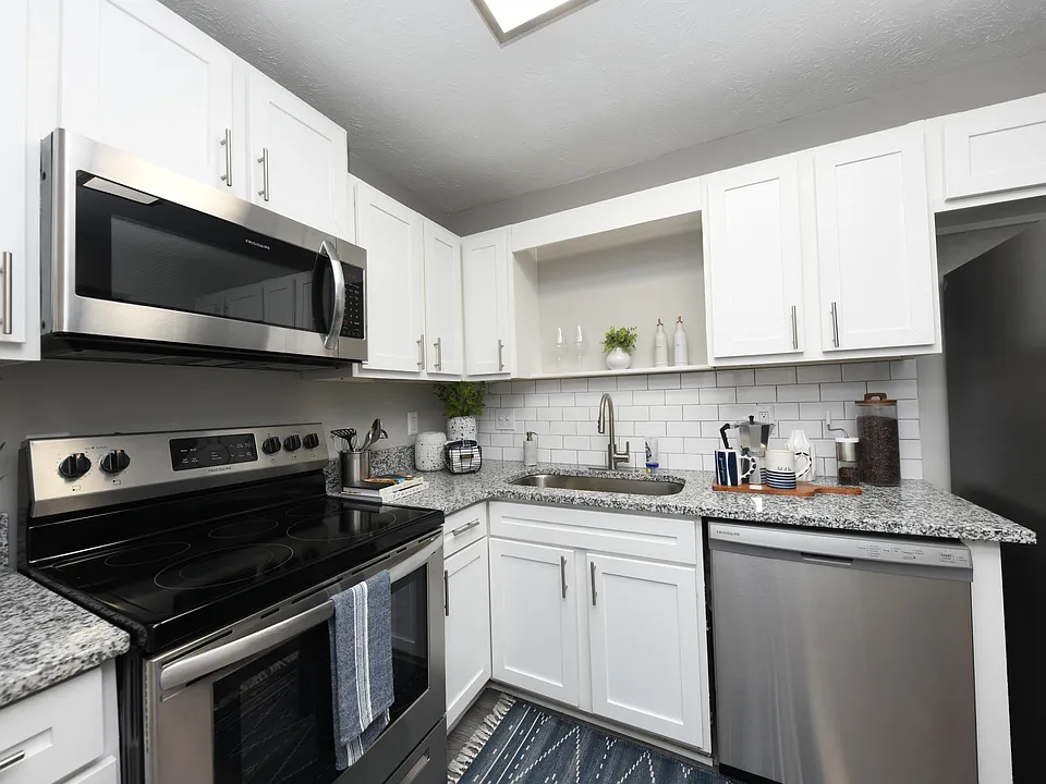 Kitchen with granite counters, modern cabinetry, and stainless appliances