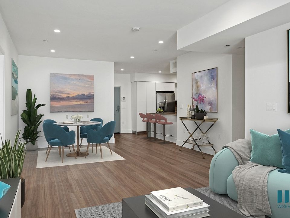 Open-Concept Dining and Living Room with Vinyl Flooring and Recessed Lighting