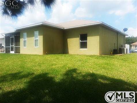 Back view of the house with the A/C and water softener equipment on the side.