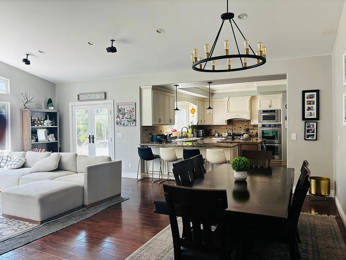 Chandelier in the dining room and well-decorated living and kitchen - 14898 Rossmoyne Dr