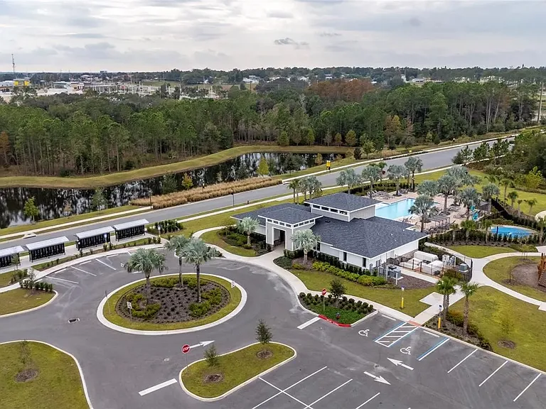 Aerial view of The Sanctuary community highlighting clubhouse, pool, walking paths, and surrounding green spaces.