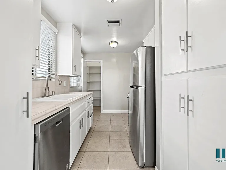 Kitchen with Stainless-Steel Appliances, Cabinet Storage, and Pantry