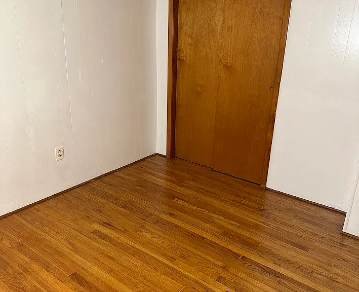 Larger of the 2 bedrooms. Hardwood floors. Large closet full length of wall.
