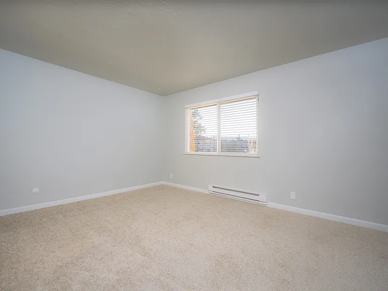 Experience the comfort of this airy bedroom, perfect for relaxation and personalization.