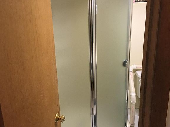 Small compact bathroom with enclosed shower. Good water pressure.