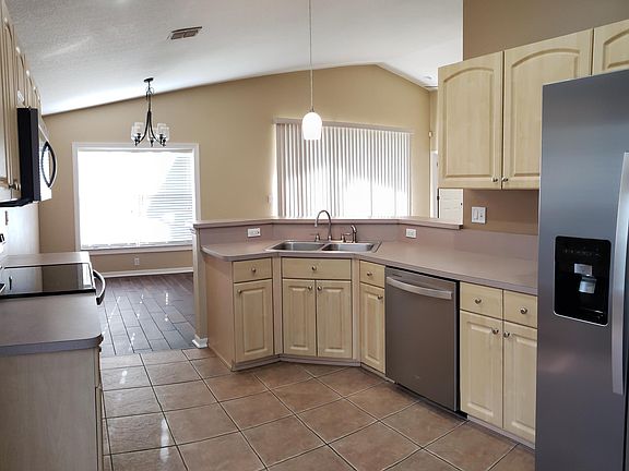 Open kitchen with new stainless steel appliances