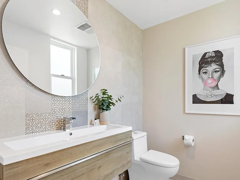The main floor half bathroom has a clean and pleasant atmosphere.