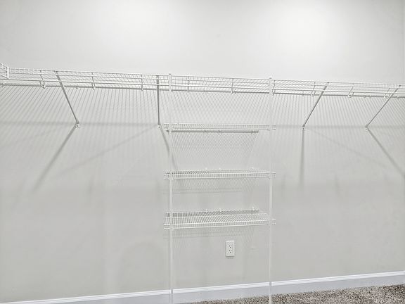 The walk-in closet off of the primary bathroom offers an abundance of space.