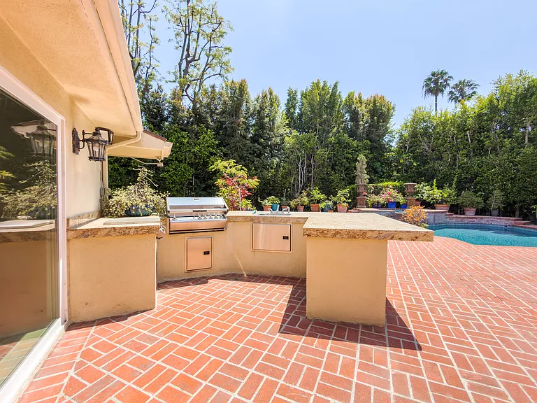 Built-in outdoor kitchen with BBQ counters overlooks the pool at this Beverly Hills luxury rental, 1094 Garden Lane, ideal for an executive rental.