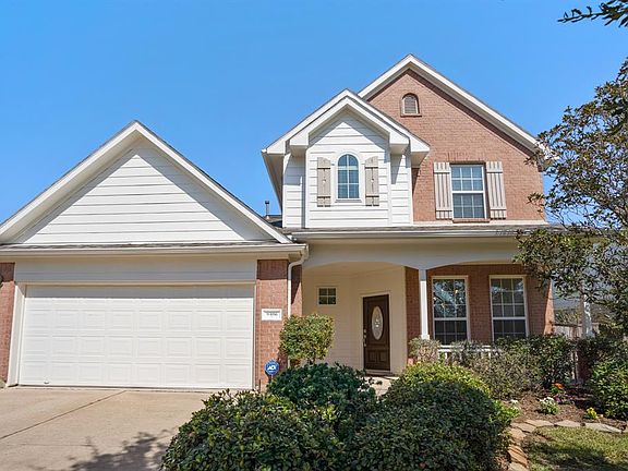 Dual wide driveway, with 2 car garage leads to covered front porch with a Recent Roof 9/20 and fresh landscaping.