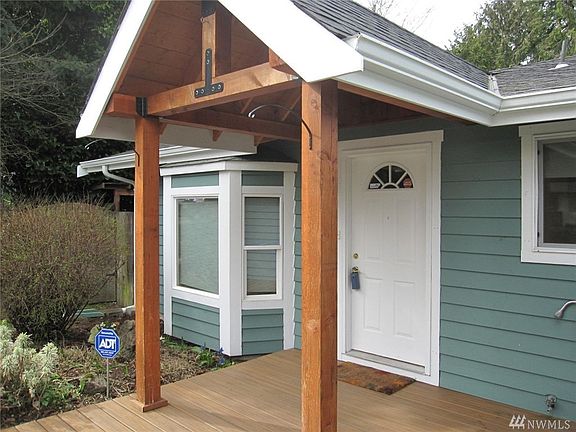Custom post & beam covered porch with bay window off living room