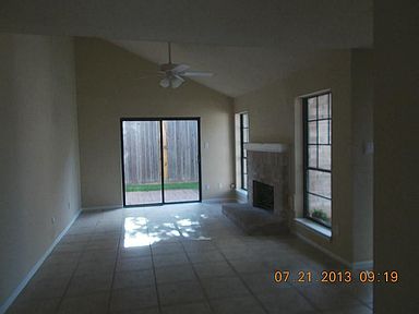 Large living area with  high ceiling & patio doors leading outside. Plenty of windows .