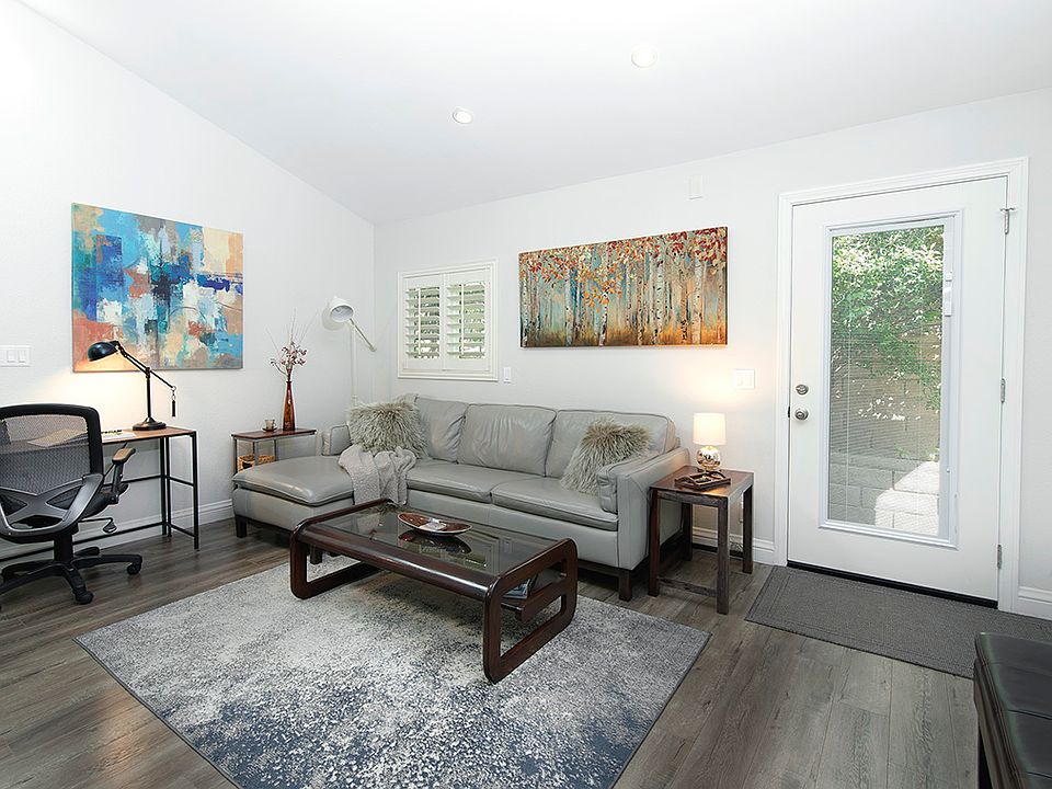 Primary lounge and SmartTV area with a work station and office chair.