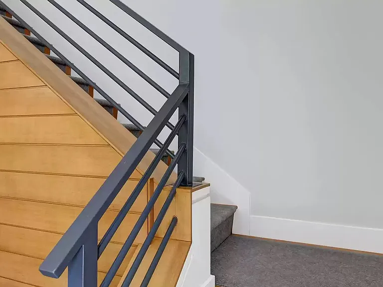 Staircase to two master bedroom suites.