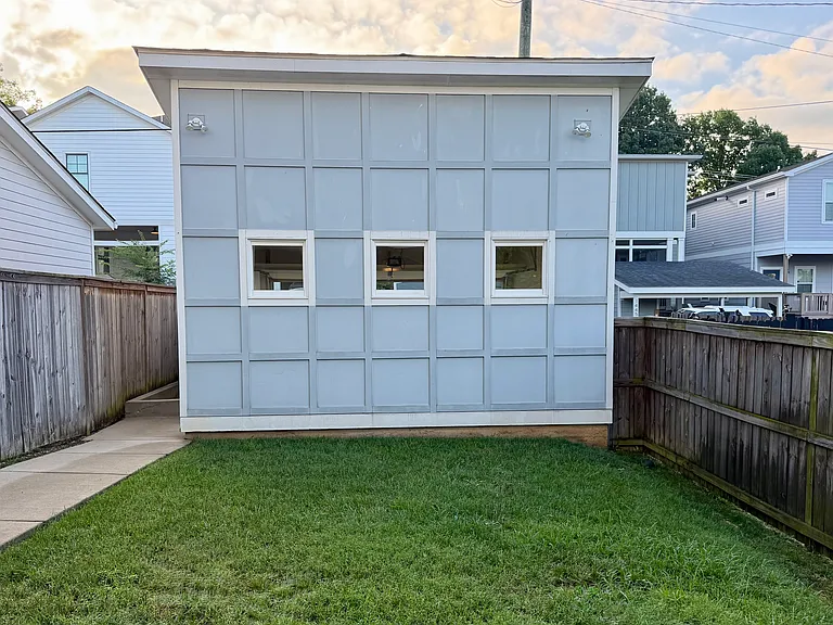 Fun view of the contemporary garage front, which adds privacy to the covered patio area