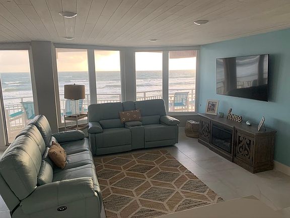 Living room with electric fireplace, 65" smart tv and reclining leather seats