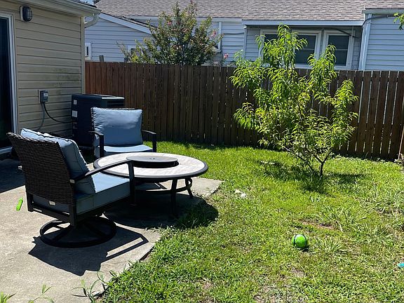 Fenced-in backyard with patio