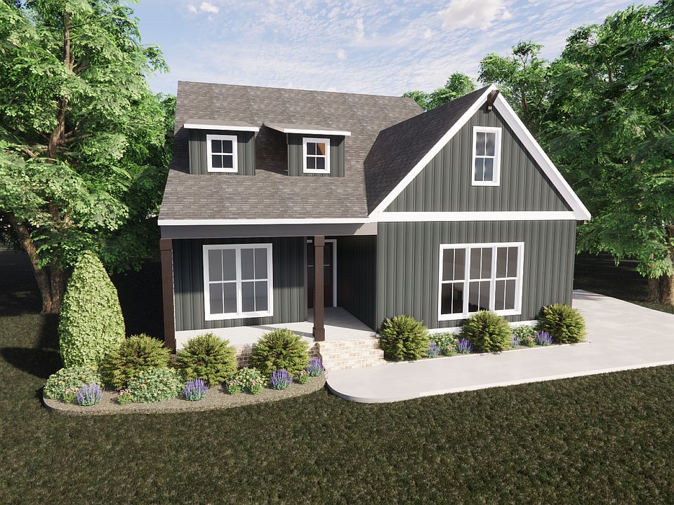 A modern dark gray Somerset Hill house with white trim, a front porch, surrounded by trees and lands