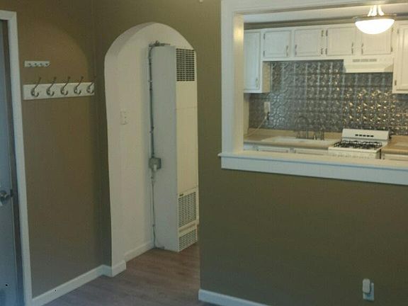 Looking from living room through portico and archway into updated kitchen