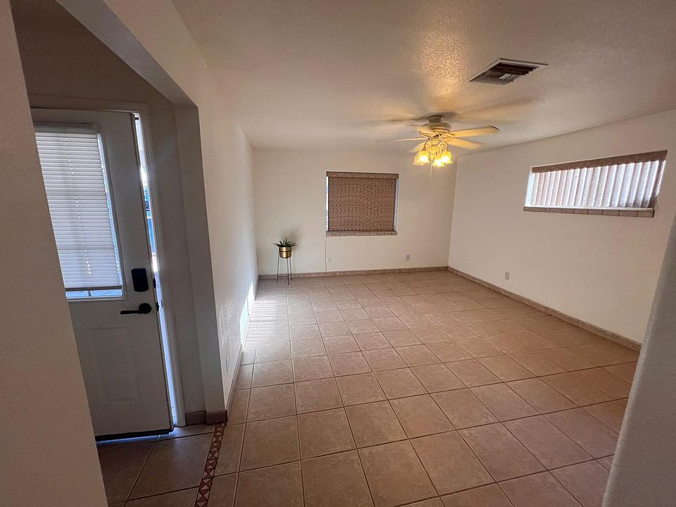 Bright and spacious living room with ceiling fan.