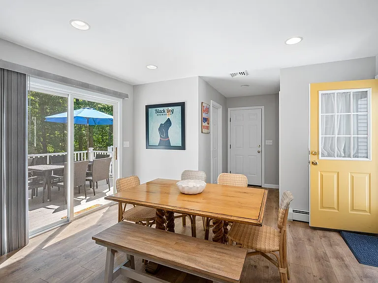 Kitchen eating area. Sliding door to back yard, door to garage & door (yellow) to front of house.