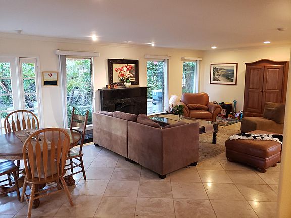 Looking from kitchen across eating area and main living room. Other tenants have had sofa facing fireplace with tv to side or above fireplace.
